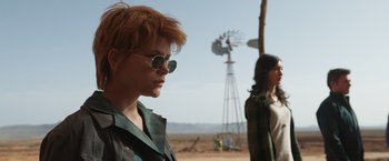Movie still from “Eternals” (2021), directed by Chloé Zhao – Two women standing next to each other in front of a windmill; Medium shot, Over the shoulder angle