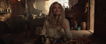 Movie still from “Eternals” (2021), directed by Chloé Zhao – A woman sitting at a table with a plate in front of her; Medium shot, Over the shoulder angle