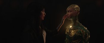 Movie still from “Eternals” (2021), directed by Chloé Zhao – A woman is touching the face of a robot; Close Up shot, Over the shoulder angle
