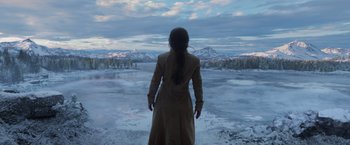 Movie still from “Eternals” (2021), directed by Chloé Zhao – A woman standing in front of a body of water; Wide shot, Over the shoulder angle