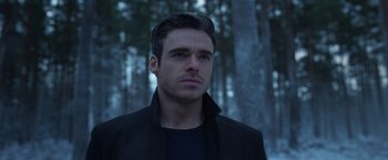 Movie still from “Eternals” (2021), directed by Chloé Zhao – A person wearing a jacket; Close Up shot, Low angle