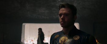 Movie still from “Eternals” (2021), directed by Chloé Zhao – A man and a woman standing next to each other; Close Up shot, Over the shoulder angle