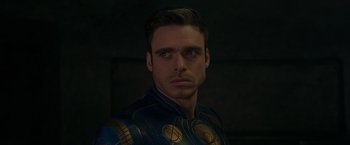 Movie still from “Eternals” (2021), directed by Chloé Zhao – A person wearing a costume; Close Up shot, Over the shoulder angle