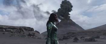 Movie still from “Eternals” (2021), directed by Chloé Zhao – A woman standing in front of an erupting volcano; Wide shot, Low angle