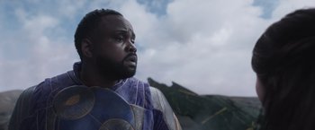 Movie still from “Eternals” (2021), directed by Chloé Zhao – A black man with a beard is looking at the sky; Close Up shot, Over the shoulder angle