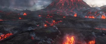 Movie still from “Eternals” (2021), directed by Chloé Zhao – A man standing on top of a lava field; Extreme Wide shot, High angle