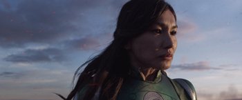 Movie still from “Eternals” (2021), directed by Chloé Zhao – A person with long black hair; Close Up shot, Low angle