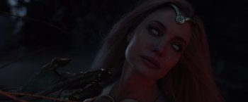 Movie still from “Eternals” (2021), directed by Chloé Zhao – A person holding a green object; Close Up shot, High angle