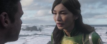 Movie still from “Eternals” (2021), directed by Chloé Zhao – A person with long hair; Close Up shot, Over the shoulder angle