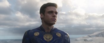 Movie still from “Eternals” (2021), directed by Chloé Zhao – A person wearing a costume; Close Up shot, Over the shoulder angle