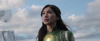 Movie still from “Eternals” (2021), directed by Chloé Zhao – A person wearing a green and yellow costume; Close Up shot, Low angle