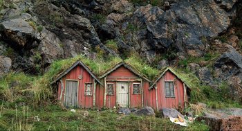 Movie still from “Eurovision Song Contest: The Story of Fire Saga” (2020), directed by David Dobkin – A group of three houses that have grass on the roof; Extreme Wide shot, Low angle