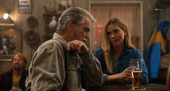 Movie still from “Eurovision Song Contest: The Story of Fire Saga” (2020), directed by David Dobkin – A man and a woman sitting at a table talking; Medium shot, Over the shoulder angle