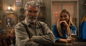 Movie still from “Eurovision Song Contest: The Story of Fire Saga” (2020), directed by David Dobkin – A man and a woman sitting at a table in front of each other; Close Up shot, Over the shoulder angle