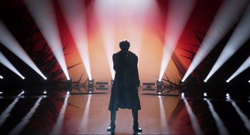 Movie still from “Eurovision Song Contest: The Story of Fire Saga” (2020), directed by David Dobkin – A man standing in front of a stage with lights; Wide shot, Low angle