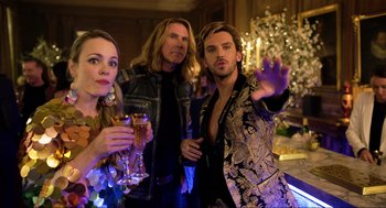 Movie still from “Eurovision Song Contest: The Story of Fire Saga” (2020), directed by David Dobkin – A group of people standing next to each other holding wine glasses; Medium shot, Over the shoulder angle