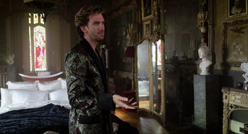 Movie still from “Eurovision Song Contest: The Story of Fire Saga” (2020), directed by David Dobkin – A man in a robe standing in front of a mirror; Medium shot, Over the shoulder angle