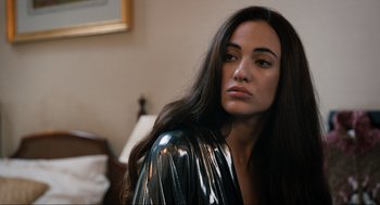 Movie still from “Eurovision Song Contest: The Story of Fire Saga” (2020), directed by David Dobkin – A woman with long black hair wearing a shiny jacket; Close Up shot, Over the shoulder angle