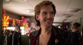 Movie still from “Eurovision Song Contest: The Story of Fire Saga” (2020), directed by David Dobkin – A man with long blonde hair smiling; Close Up shot, Over the shoulder angle
