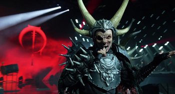 Movie still from “Eurovision Song Contest: The Story of Fire Saga” (2020), directed by David Dobkin – A man dressed as a demon wearing a horned helmet; Medium shot, High angle