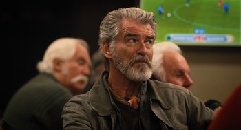Movie still from “Eurovision Song Contest: The Story of Fire Saga” (2020), directed by David Dobkin – A man with a gray beard is sitting in front of a group of other men; Close Up shot, Over the shoulder angle