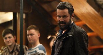 Movie still from “Eurovision Song Contest: The Story of Fire Saga” (2020), directed by David Dobkin – A man with long hair and a goatee standing next to another man; Medium shot, Over the shoulder angle