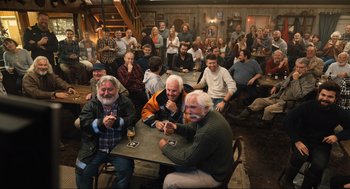 Movie still from “Eurovision Song Contest: The Story of Fire Saga” (2020), directed by David Dobkin – A group of people sitting at a table with drinks; Wide shot, High angle