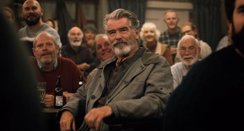 Movie still from “Eurovision Song Contest: The Story of Fire Saga” (2020), directed by David Dobkin – An older man sitting in front of a group of older people; Medium shot, Over the shoulder angle