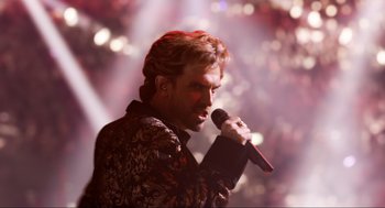 Movie still from “Eurovision Song Contest: The Story of Fire Saga” (2020), directed by David Dobkin – A man holding a microphone while standing in front of a crowd; Close Up shot, Low angle