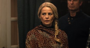 Movie still from “Eurovision Song Contest: The Story of Fire Saga” (2020), directed by David Dobkin – A woman with blonde hair wearing a red and gold shawl; Close Up shot, Low angle