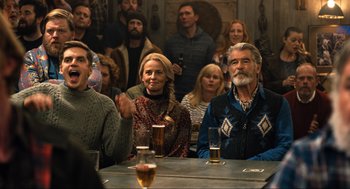 Movie still from “Eurovision Song Contest: The Story of Fire Saga” (2020), directed by David Dobkin – A group of people sitting at a table with drinks; Medium shot, Over the shoulder angle