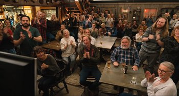 Movie still from “Eurovision Song Contest: The Story of Fire Saga” (2020), directed by David Dobkin – A group of people sitting at tables with beers on the table; Wide shot, High angle