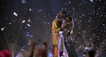 Movie still from “Eurovision Song Contest: The Story of Fire Saga” (2020), directed by David Dobkin – A man and a woman kissing in front of confetti; Wide shot, Over the shoulder angle