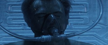 Movie still from “Event Horizon” (1997), directed by Paul W.S. Anderson – A man with a gas mask is in a shower; Close Up shot, Overhead angle