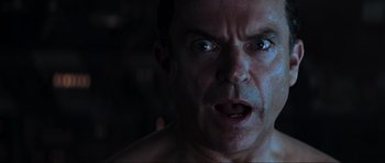 Movie still from “Event Horizon” (1997), directed by Paul W.S. Anderson – A man's face in a dark room; Close Up shot, Low angle