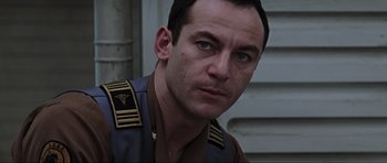 Movie still from “Event Horizon” (1997), directed by Paul W.S. Anderson – A person wearing a uniform; Close Up shot, Low angle