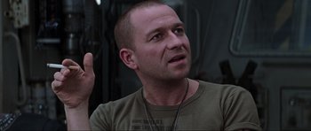 Movie still from “Event Horizon” (1997), directed by Paul W.S. Anderson – A man with a bald head is talking to someone; Close Up shot, Over the shoulder angle