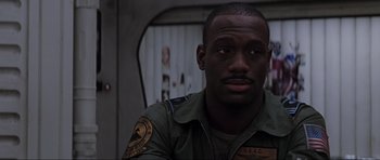 Movie still from “Event Horizon” (1997), directed by Paul W.S. Anderson – A man in a military uniform is looking at the camera; Close Up shot, Low angle
