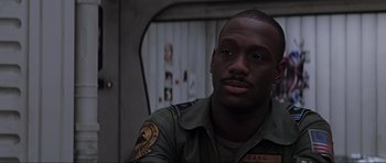 Movie still from “Event Horizon” (1997), directed by Paul W.S. Anderson – A man in a military uniform is looking at the camera; Close Up shot, Low angle