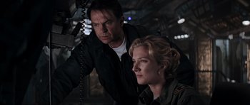 Movie still from “Event Horizon” (1997), directed by Paul W.S. Anderson – A man and a woman standing next to each other; Close Up shot, Low angle