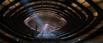Movie still from “Event Horizon” (1997), directed by Paul W.S. Anderson – A group of people standing inside of an underground tunnel; Extreme Wide shot, Overhead angle