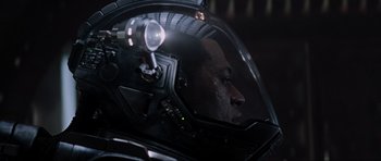 Movie still from “Event Horizon” (1997), directed by Paul W.S. Anderson – A man's face in a helmet; Close Up shot, Over the shoulder angle