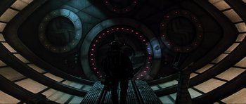 Movie still from “Event Horizon” (1997), directed by Paul W.S. Anderson – A man standing inside of an underground tunnel; Wide shot, Overhead angle