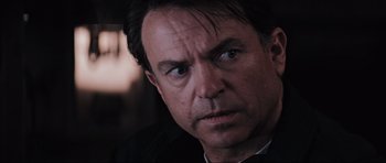 Movie still from “Event Horizon” (1997), directed by Paul W.S. Anderson – A person wearing a suit and tie; Close Up shot, Over the shoulder angle