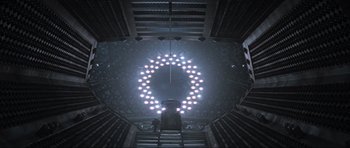 Movie still from “Event Horizon” (1997), directed by Paul W.S. Anderson – A person standing on a ladder in a room with lights; Extreme Wide shot, Overhead angle