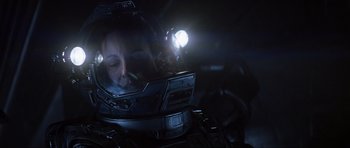 Movie still from “Event Horizon” (1997), directed by Paul W.S. Anderson – A woman wearing a helmet with a light shining on her head; Close Up shot, Overhead angle