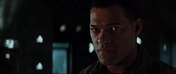 Movie still from “Event Horizon” (1997), directed by Paul W.S. Anderson – A man's face in a dimly - lit room; Close Up shot, Low angle