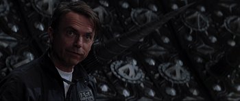 Movie still from “Event Horizon” (1997), directed by Paul W.S. Anderson – A person wearing a uniform; Close Up shot, Low angle