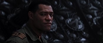 Movie still from “Event Horizon” (1997), directed by Paul W.S. Anderson – A man's face in front of a wall; Close Up shot, Low angle