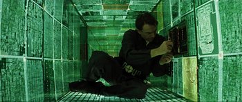 Movie still from “Event Horizon” (1997), directed by Paul W.S. Anderson – A man in black shirt and black pants crouching on the ground; Medium shot, Overhead angle